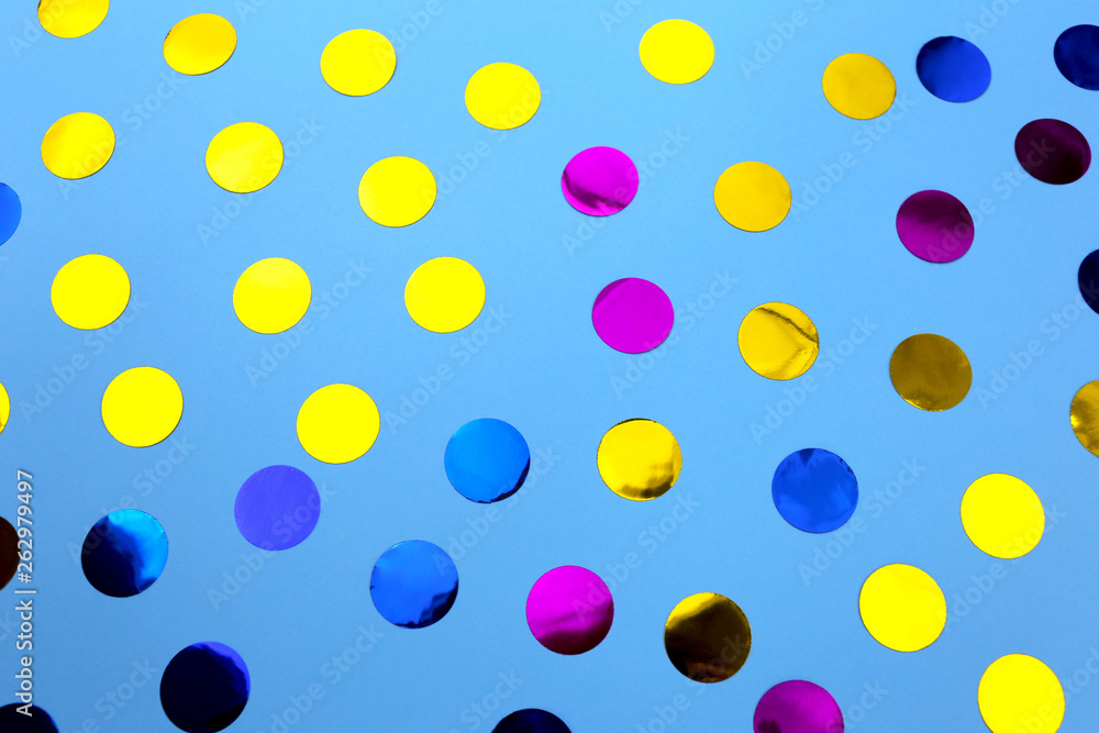 Round confetti on blue background. Festive design. There is a place for text.