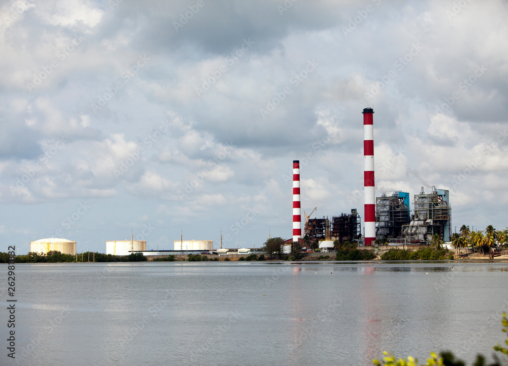 Cuba. Industrial factory buildings by the sea