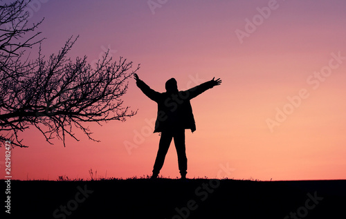 Silhouette of a boy child against the backdrop of a beautiful sunset.