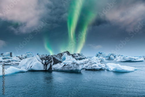 Northern light aurora borealis over glaciers. 