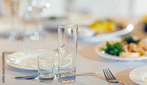 Served tables in restaurants and cafes, meals and drinks on the tables, room design.