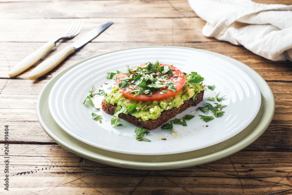 Avocado toast. Healthy toast with avocado mash and tomatoes on a plate. Avocado toast. Healthy toast with avocado mash and tomatoes on a plate.