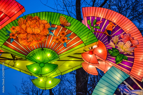 Various bright Chinese small lamps in the park. Garland. An unusual decor for streets and the house. Festive mood photo