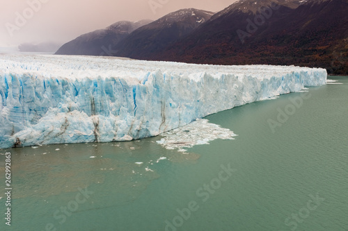 The the face of the Perito Moreno Glacier located in the Los Glaciares National Park in Santa Cruz Province, Argentina. With the autumn tree colours in the foreground