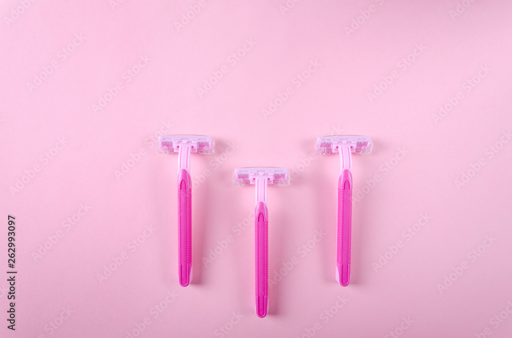 Three razor for woman on the pink background, top view.Concept of the depilation