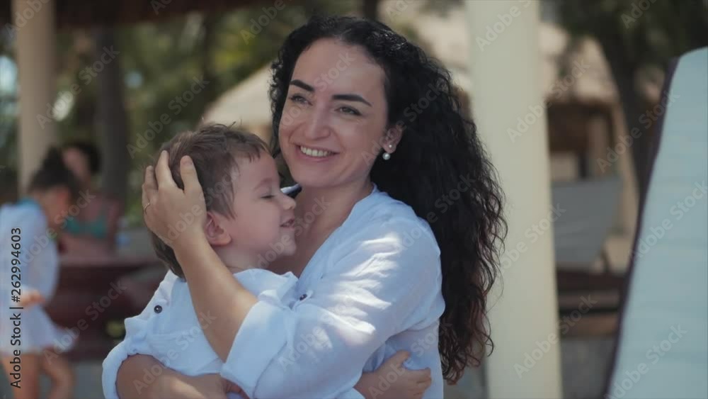 Happy Mother Hugging Her Child on the Coast. Cute Kid Kisses His Mom and Gently Hugs. Concept Mom With a Child Outdoors, Happy Family, Happy Childhood, Little Baby. Happy Mother Hugging Her Child on the Coast. Cute Kid Kisses His Mom and Gently Hugs. Concept Mom With a Child Outdoors, Happy Family, Happy Childhood, Little Baby.