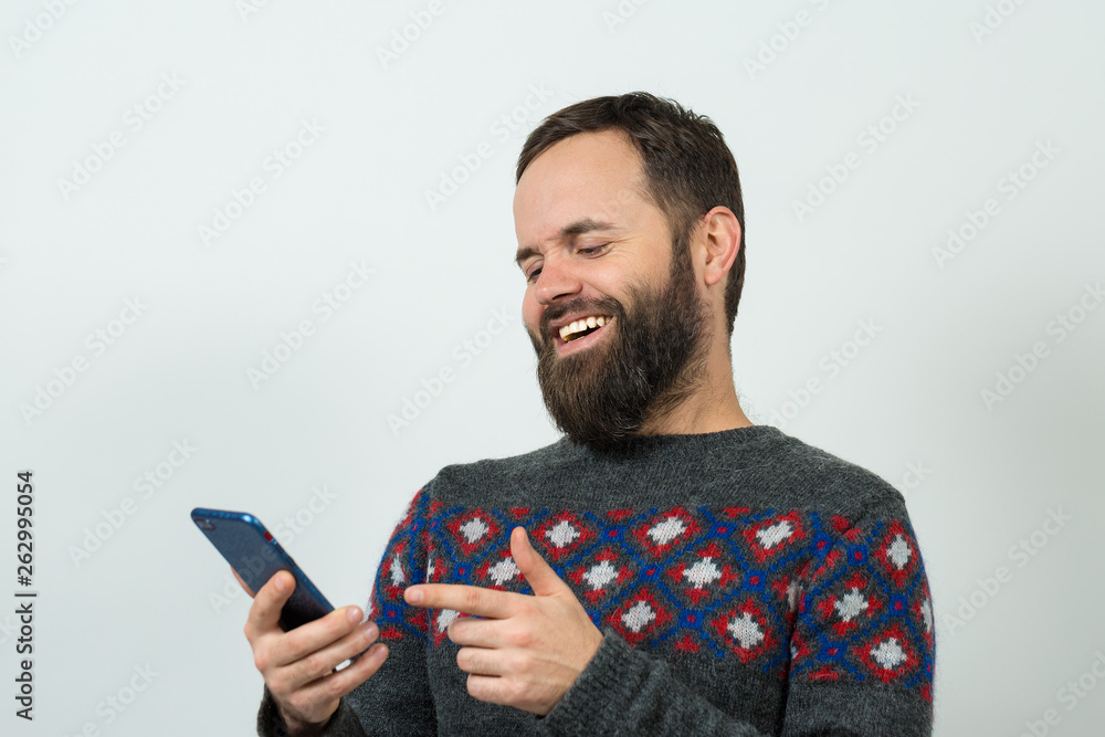 A pensive guy with a beard and glasses on a gray background ponders what to do next. Thinking about question, pensive expression, looks incredulous. A pensive guy with a beard and glasses on a gray background ponders what to do next. Thinking about question, pensive expression, looks incredulous.
