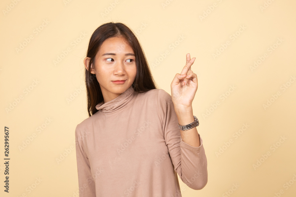 Beautiful young Asian woman cross finger. Beautiful young Asian woman cross finger.
