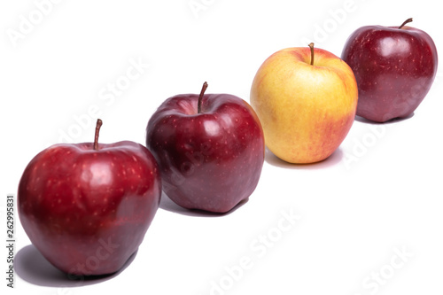 Three red apples and one yellow apple on a white background, isolated Apple. Be unique.