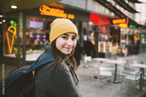 Photography Young woman walks through a street with neon signs