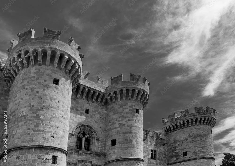 Black and white view of the Palace of the Grand Master of the Knights of Rhodes against a dramatic sky, Greece