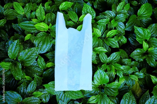 White Plastic Shopping Bag on Green Leaves the Awesome Background, Using for Say No to Plastic Bags Concept.