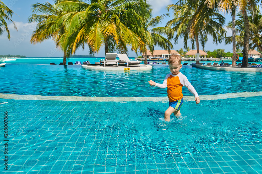 Toddler boy in resort swimming pool