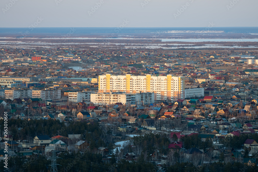 Yakutsk city downtown aerial view from hill at amazing sunset. Sunrise or sunset overlooking the new buildings of the city