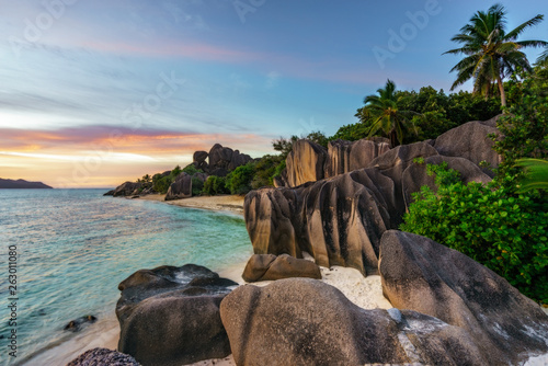 sunset over rocks,sand,palms,turquoise water at tropical beach,la dique,seychelles paradise 1 © Christian B.