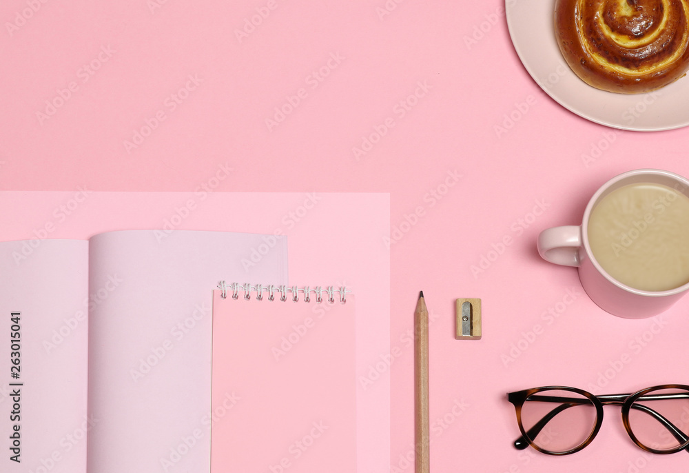 Pink notes paper, wooden pencil, sharpener, coffee cup, cake on  pink background 