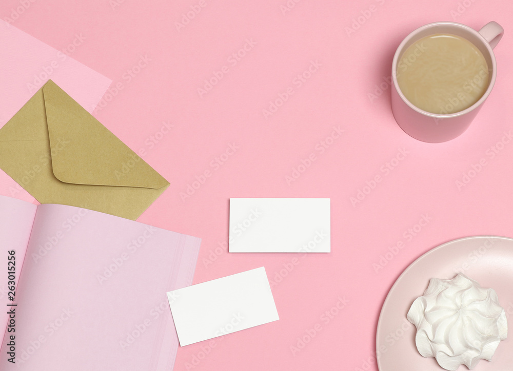 Mockup business cards on pink table with cup and cake Mockup business cards on pink table with cup and cake