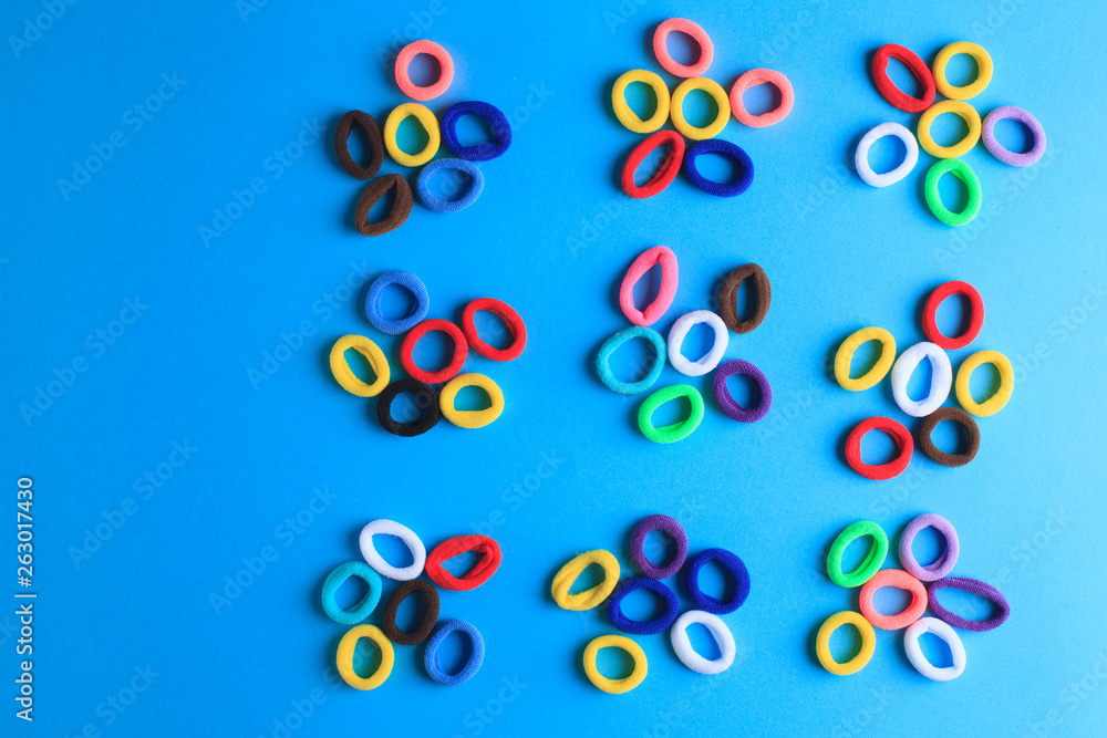 Fototapeta premium Photo of multi-colored hair elastics in the form of flowers