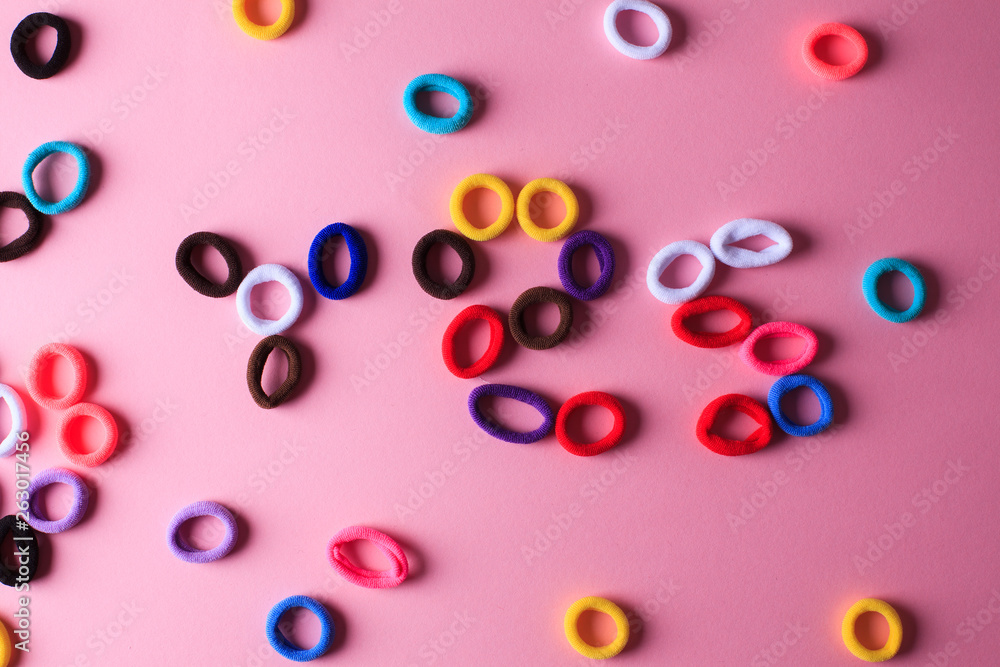 Photo with a lot of randomly lying multicolored hair elastics Photo with a lot of randomly lying multicolored hair elastics