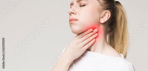 Bilde på lerret Woman suffering from sore throat, touching her neck