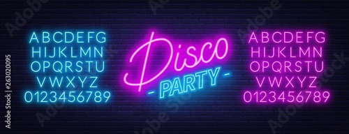 Neon text Disco party on brick wall background. Glowing fonts.