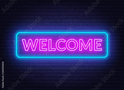 Neon sign welcome on on brick wall background.