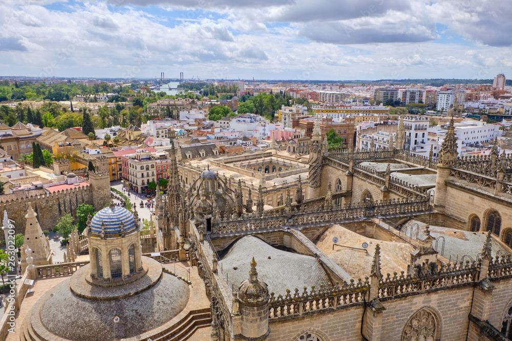 Aerial view of the Cathedral of Saint Mary of the See (Seville Cathedral) in Seville, Andalusia, Spain in a sunny and cloudy day.