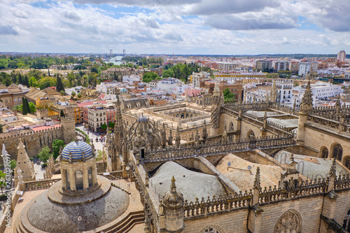 Aerial view of the Cathedral of Saint Mary of the See (Seville Cathedral) in Seville, Andalusia, Spain in a sunny and cloudy day.