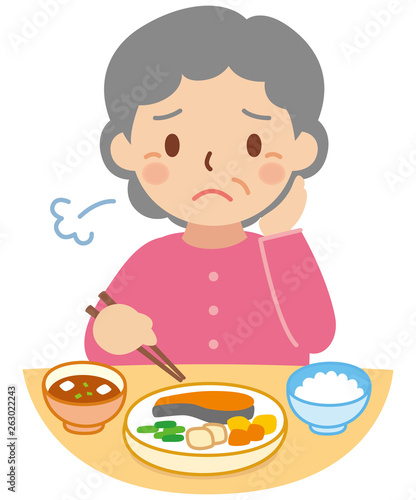 食事をする困り顔のおばあちゃん