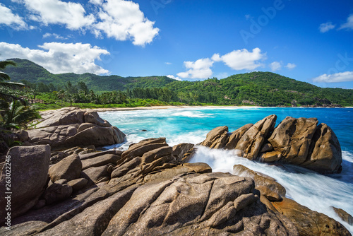 water fountain over granite rocks,wild tropical beach with palms, seychelles 34 © Christian B.