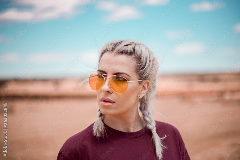 blonde woman orange glasses