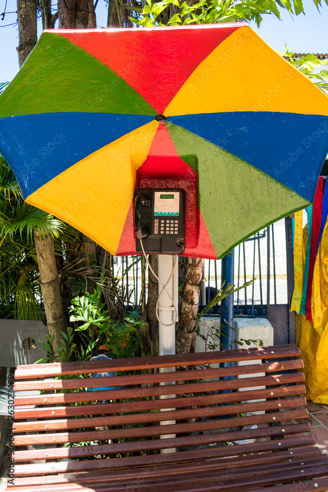 Φωτογραφία Olinda, Brazil - Circa April 2019: Public pay phone decorated with a colorful um
