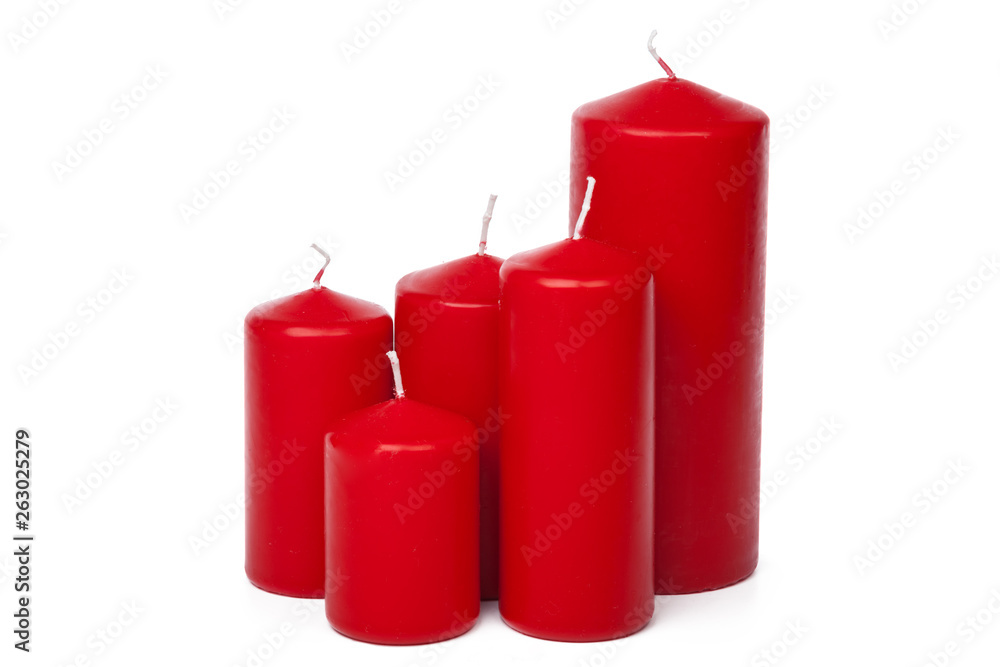A selection of red candles on a white background A selection of red candles on a white background
