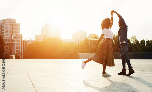 Love is in the air. Romantic couple dancing at sunset