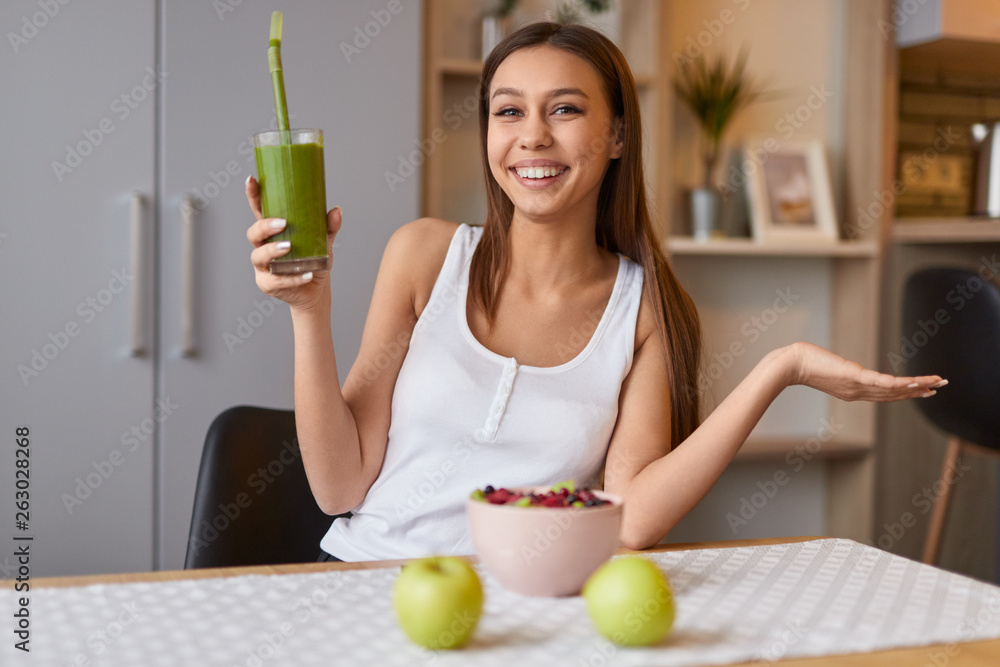 Fotografie Cheerful lady presenting smoothie recipe
