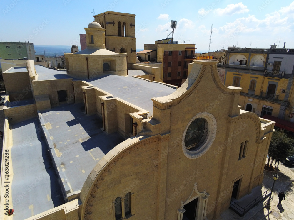 Aerial View of the Church of Santa Maria Assunta in the Town of Mottola on blue Sky Background 