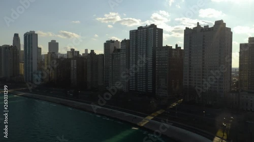Pan Left by Chicago Skyline, while over Lake Michigan - Aerial [4k]