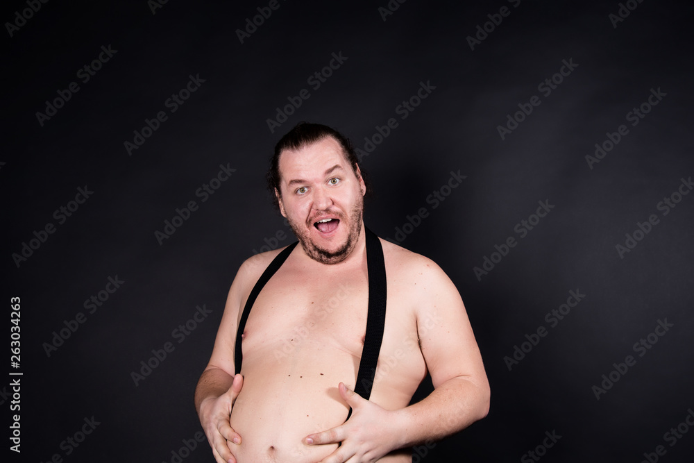 Funny fat man. Black background.
