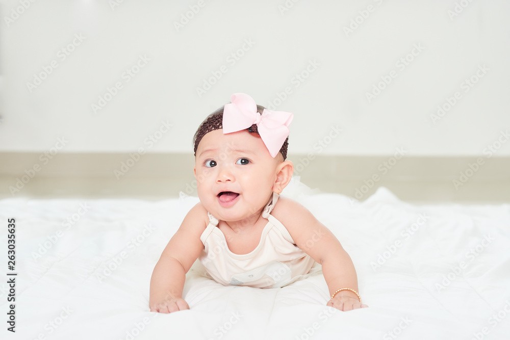 Baby girl smiling on the floor isolated on white Baby girl smiling on the floor isolated on white