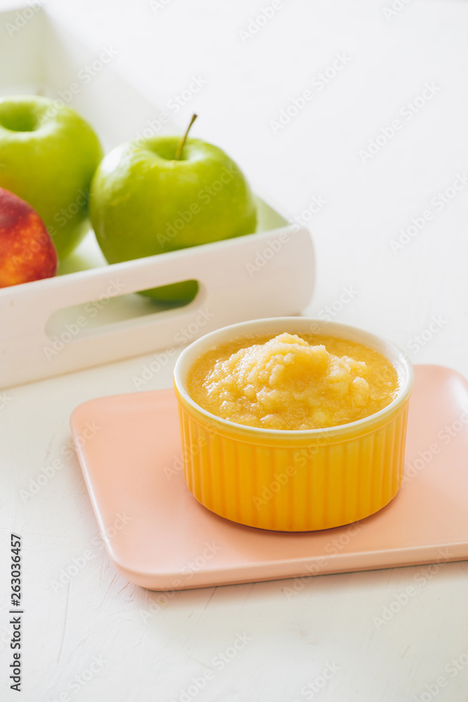 Natural baby food concept. Bowl of apple baby puree.