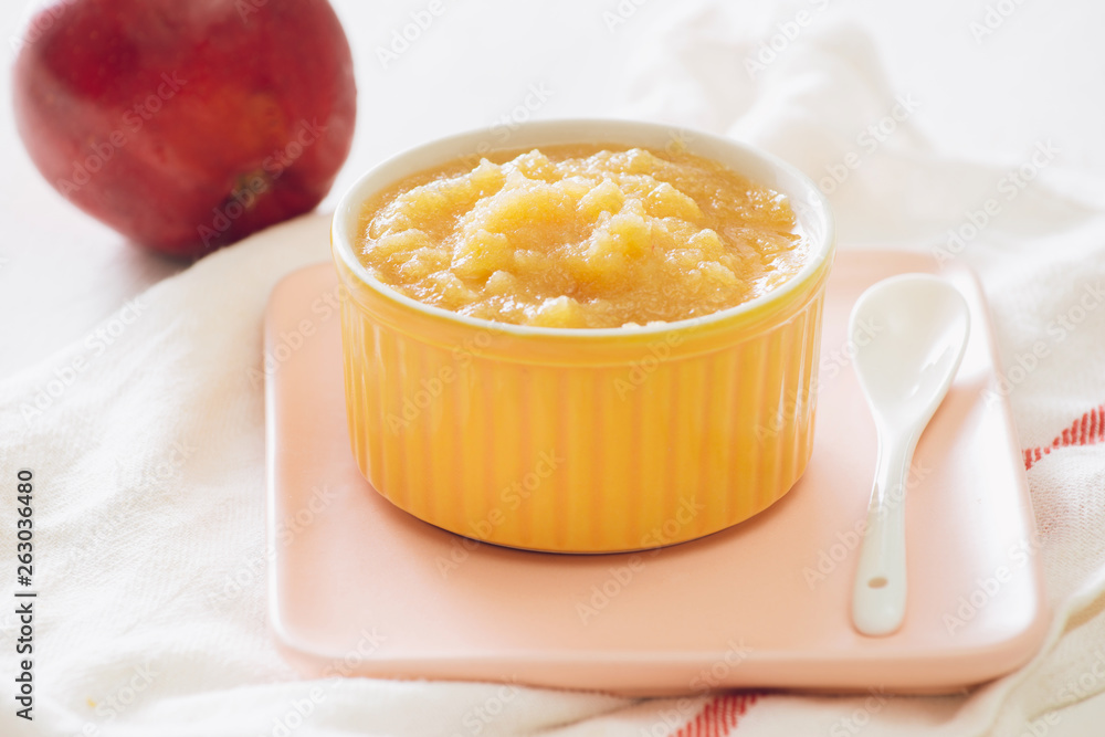 Natural baby food concept. Bowl of apple baby puree. Natural baby food concept. Bowl of apple baby puree.
