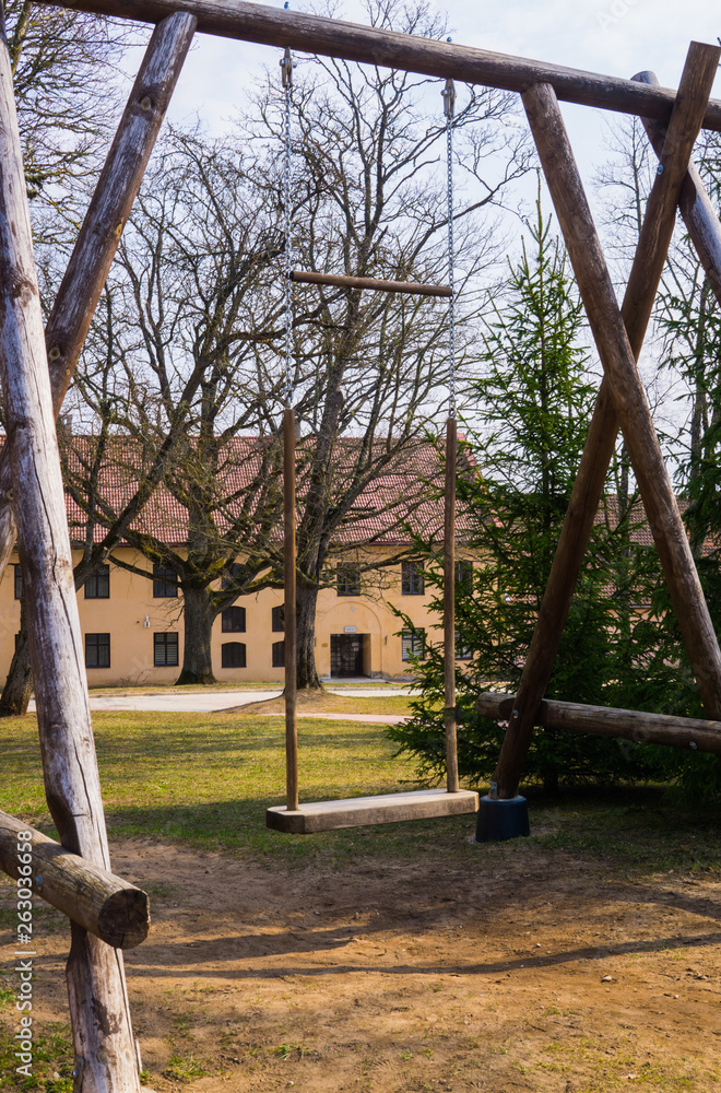 Renovated old manor Shlokenbek in Latvia.Wooden swing.7 April 2019. Renovated old manor Shlokenbek in Latvia.Wooden swing.7 April 2019.