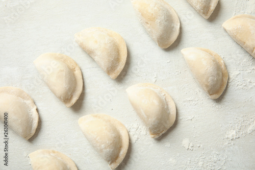 Raw dumplings on light background, top view. Process of cooking