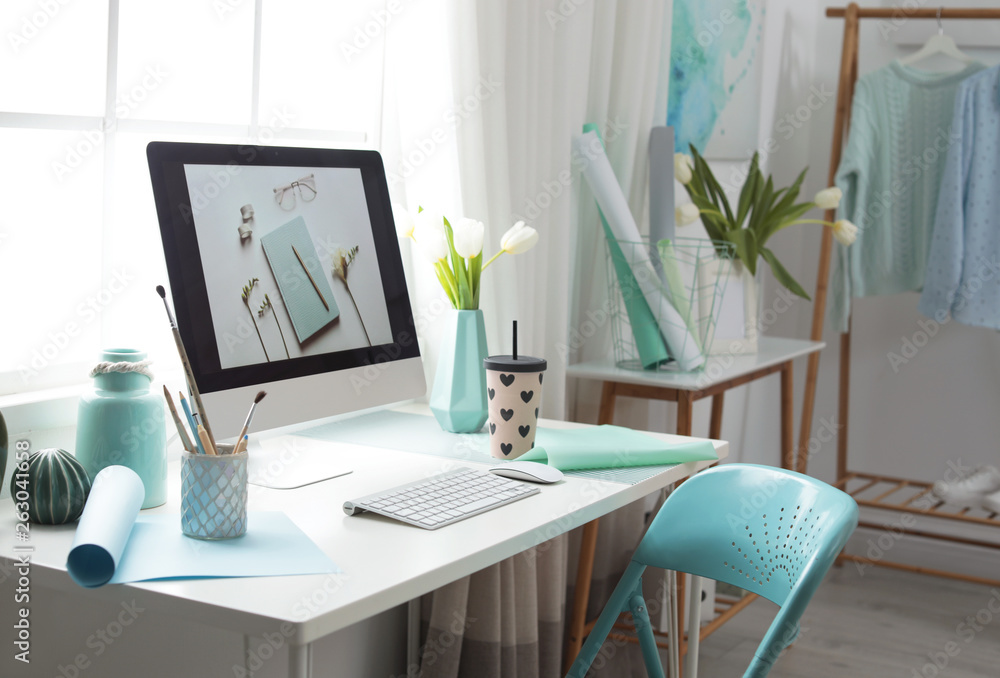 Stylish workplace interior with modern computer on desk Stylish workplace interior with modern computer on desk