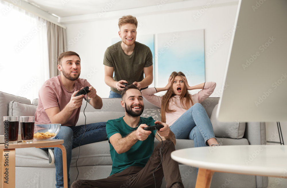 Emotional friends playing video games at home Emotional friends playing video games at home
