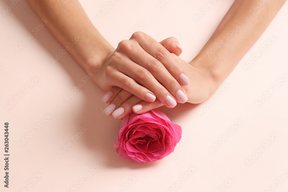 Closeup view of woman with rose on color background. Spa treatment