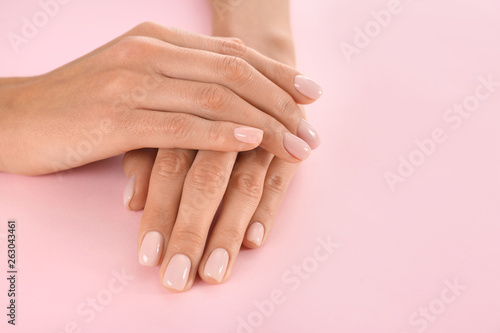 Closeup view of woman with beautiful hands on color background  space for text. Spa treatment