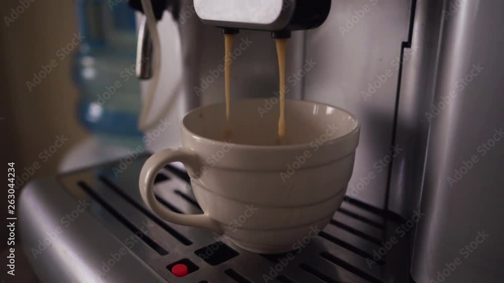 Pouring coffee stream from professional machine in cup. Flowing fresh ground coffee. Slow motion footage. Pouring coffee stream from professional machine in cup. Flowing fresh ground coffee. Slow motion footage.