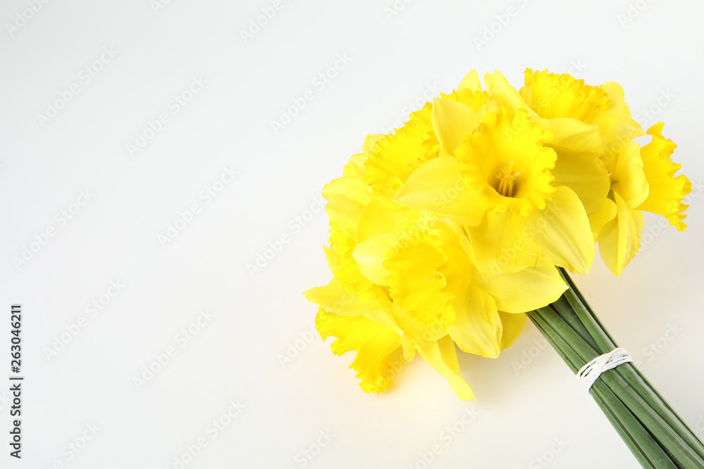 Bouquet of daffodils on white background, top view. Fresh spring flowers
