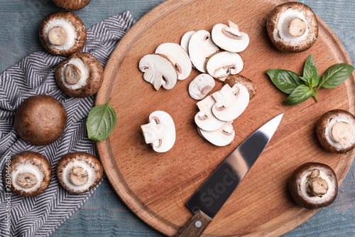 Flat lay composition with fresh raw mushrooms on wooden table